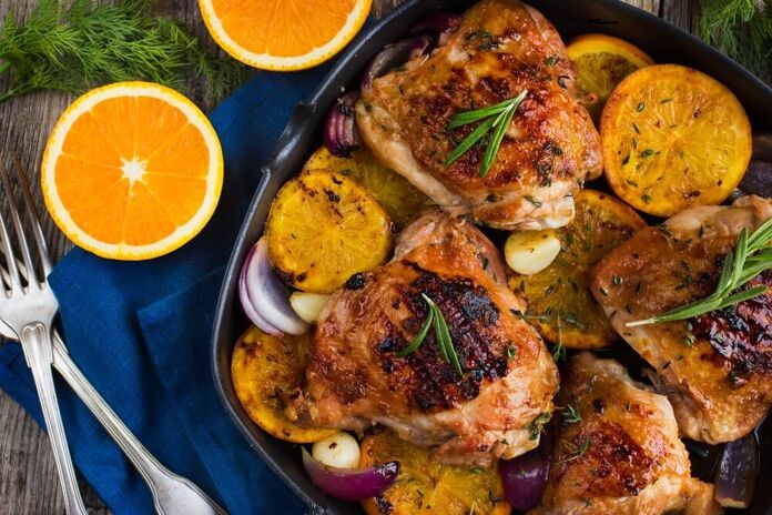 Delicious baked chickens with orange and rosemary